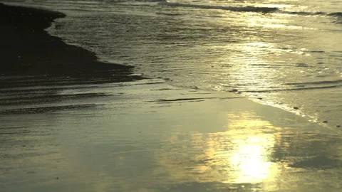 Golden sand with rolling waves at sunset Stock Footage 112953156