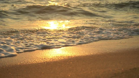 Golden sand with rolling waves at sunset Stock Footage 112953160