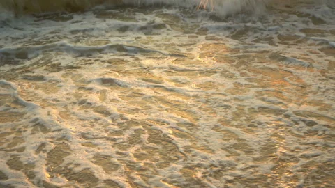 Golden sand with rolling waves at sunset Stock Footage 112953234