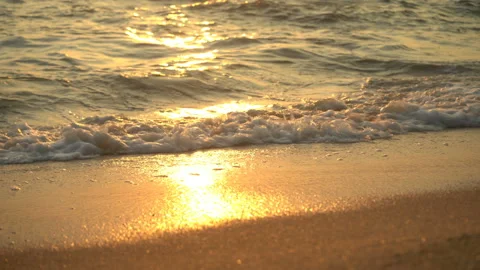 Golden sand with rolling waves at sunset Stock Footage 112953271