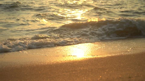 Golden sand with rolling waves at sunset Stock Footage 112953289