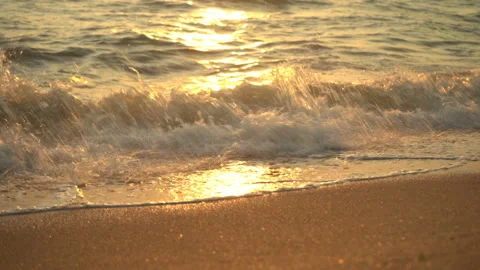 Golden sand with rolling waves at sunset Stock Footage 112953290