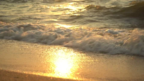 Golden sand with rolling waves at sunset Stock Footage 112953328