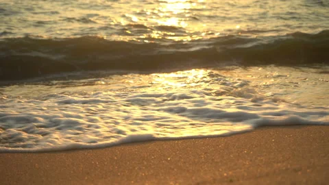 Golden sand with rolling waves at sunset Stock Footage 112953335