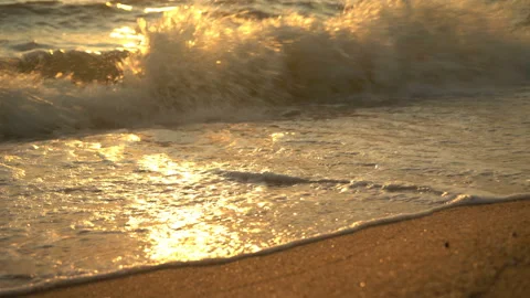 Golden sand with rolling waves at sunset Stock Footage 112953385
