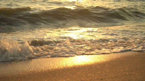 Golden sand with rolling waves at sunset Stock Footage 112953396