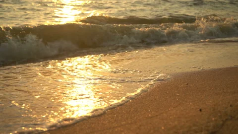 Golden sand with rolling waves at sunset Stock Footage 112953445