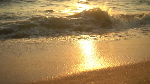 Golden sand with rolling waves at sunset Stock Footage 112953499