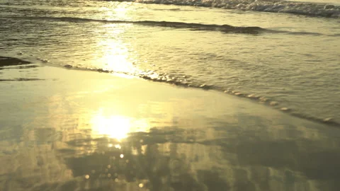 Golden sand with rolling waves at sunset Stock Footage 112953847