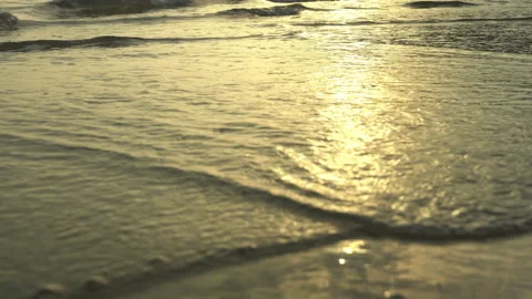 Golden sand with rolling waves at sunset Stock Footage 112953858
