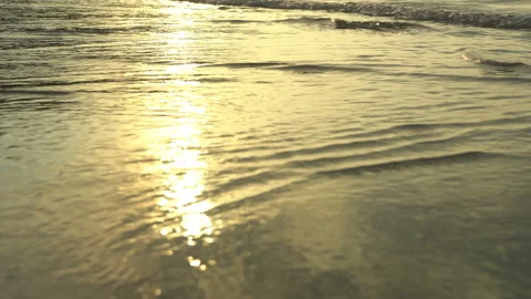 Golden sand with rolling waves at sunset Stock Footage 112953972