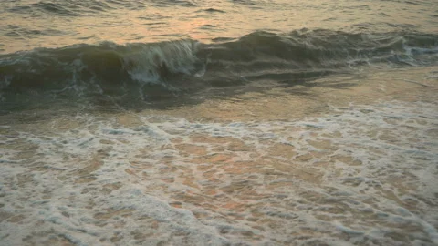 Golden sand with rolling waves at sunset Stock Footage 113416495