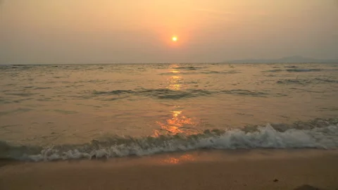 Golden sand with rolling waves at sunset Stock Footage 113416622