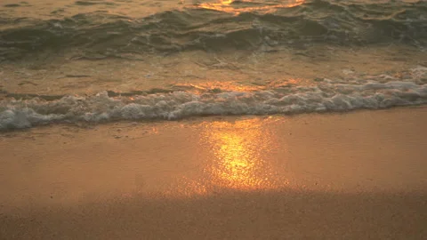 Golden sand with rolling waves at sunset Stock Footage 113417170