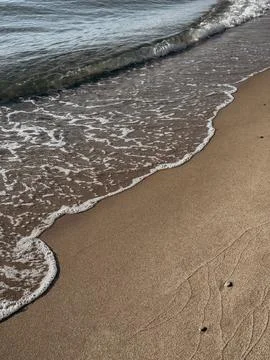 Golden sand surface with deep human footprints in warm sunlight showing bea.. Stock Photos