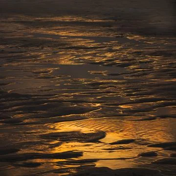 Golden Sand Texture with Reflections at Sunset Stock Photos