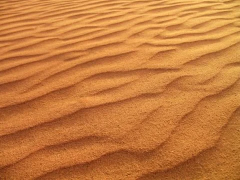 Golden sand waves and sunset shadows in the Jordan desert Stock Photos