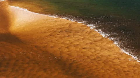 Golden Sandbar Patterns Under Shallow Surf, Coastal Flyover Stock Footage 343439538