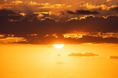 Golden Scenic Cloudscape and dramatic blue sky during sea sunrise Stock Photos