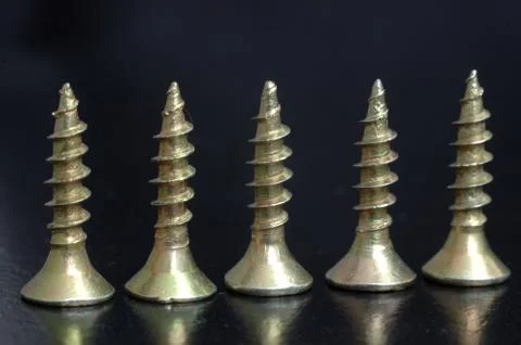 Golden screws Stock Photos