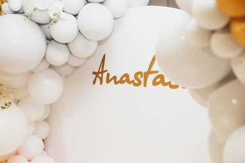 Golden script spells out name against soft white backdrop Foto stock