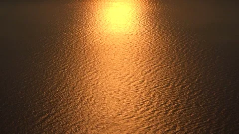 Golden sea surface glows at sunset, empty water background with calm ripples Stock Footage 339819978