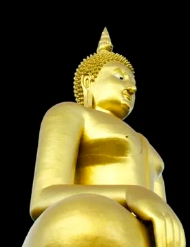 Golden seated buddha image on solid black background Stock Photos
