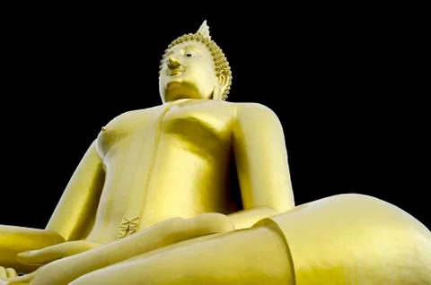 Golden seated buddha image on solid black background Stock Photos