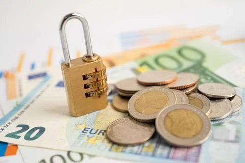 Golden security digital password lock key and coins with with Euro banknote.. Stock Photos