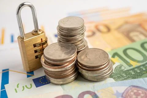 Golden security digital password lock key and coins with with Euro banknote.. Stock Photos