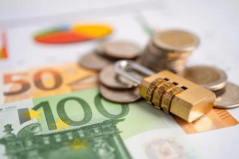 Golden security digital password lock key and coins with with Euro banknote.. Stock Photos