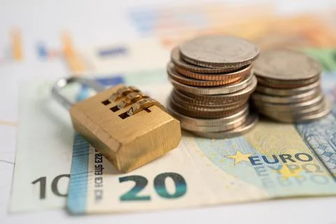 Golden security digital password lock key and coins with with Euro banknote.. Stock Photos