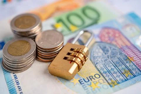 Golden security digital password lock key and coins with with Euro banknote.. Stock Photos