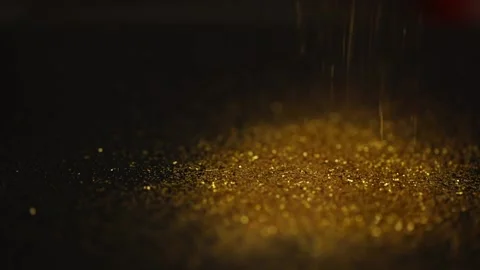 Golden sequins fall on a black glitter background Stock Footage 223403521