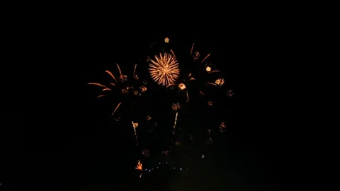 Golden shining fireworks exploding in the night sky. Glowing fireworks Stock Footage 245820175
