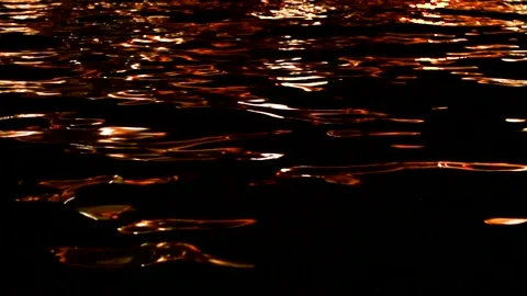 Golden shiny liquid flows and overflows. Dark water. Stock Footage 224849573