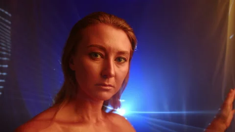 Golden Skinned Model Posing by Sheer Curtains with Projector Beams Behind Stock Footage 259083410