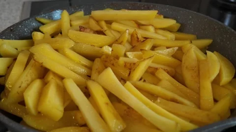 Golden Slices Sizzling in the Pan While Being Prepared for a Delicious Homemade Stock Footage 287837157