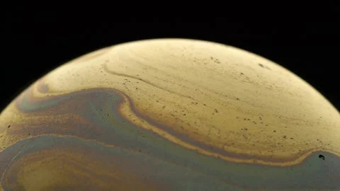 Golden soap bubble with an amazing pattern. Close-up. Stock Footage 145124545