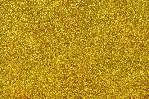 Golden sparkling background from small sequins. Shimmer yellow paper Stock Photos