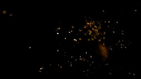 Golden sparks fly against solid black background Stock Footage 326756362