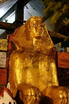 Golden Sphinx Statue with Rough Texture and Night Lighting Photos