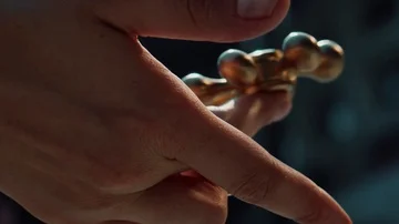 Golden spinner rolling on the finger Stock Footage 86029582