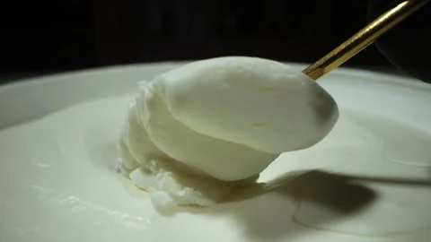 The golden spoon scoops up a portion of white cottage cheese Vidéo 275146034