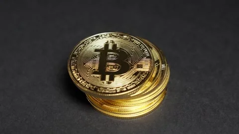 Golden stack of Bitcoin tokens symbolizing wealth and modern digital finance Stock Footage 312030820