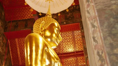 Golden standing Buddha statue inside a Thai temple 動画素材 322561189