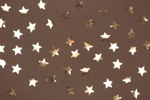 Golden star pattern on a mocha and mousse background for festive decor Stock Photos