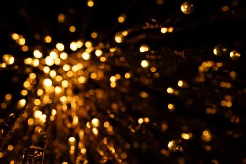 Golden string lights in radial pattern, abstract festive illumination, blurre Stock Photos