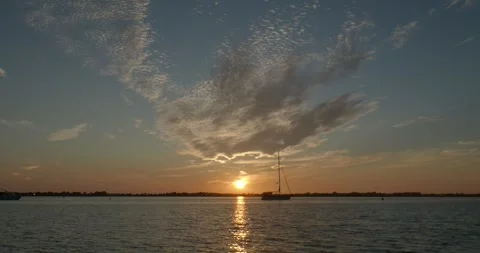 Golden summer sunset with clouds at Fehmarn coastline with ships driving by Stock Footage 287186315