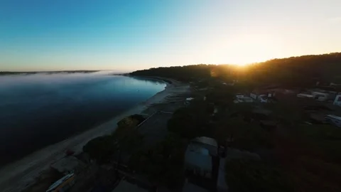 Golden sun breaks over misty sea at dawn Stock Footage 340903698